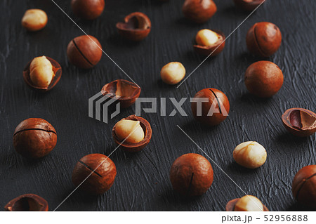 Purified and shell repeats macadamia nuts on black Purified and shell repeats macadamia nuts on black 52956888