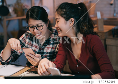 two happy students looking at smartphone laughing two happy students looking at smartphone laughing 52958204