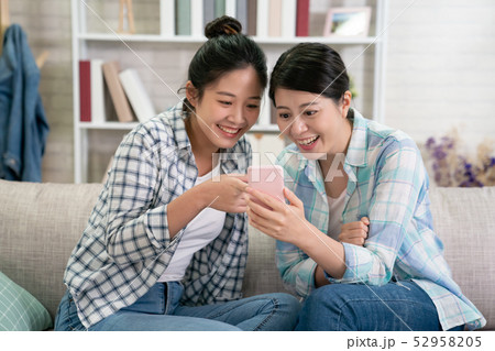 girls sharing cellphone screen point excited girls sharing cellphone screen point excited 52958205