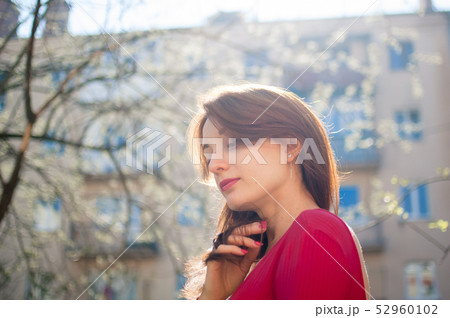 Attractive cheerful girl with cute healthy smile and sensual lips enjoying spring in the city during 52960102