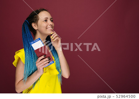 A modern trendy smiling woman in yellow dress with 52964500