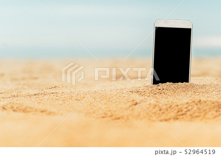 smartphone in the sand on a beach with blank white 52964519