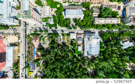 Aerial city view with crossroads and roads, houses, buildings, parks and parking lots. Sunny summer Aerial city view with crossroads and roads, houses, buildings, parks and parking lots. Sunny summer 52967307