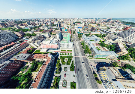 Aerial city view with crossroads and roads, houses, buildings, parks and parking lots. Sunny summer Aerial city view with crossroads and roads, houses, buildings, parks and parking lots. Sunny summer 52967329