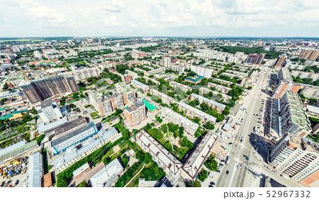 Aerial city view with crossroads and roads, houses, buildings, parks and parking lots. Sunny summer Aerial city view with crossroads and roads, houses, buildings, parks and parking lots. Sunny summer 52967332