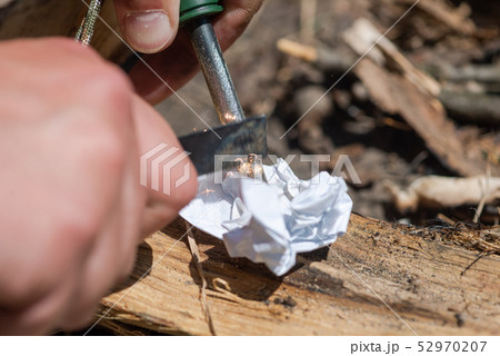 Make fire by friction with with flint and steel 52970207