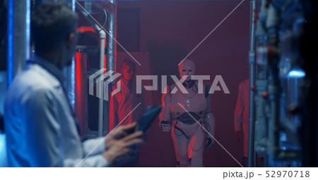 Scientist checking equipment and using tablet 52970718