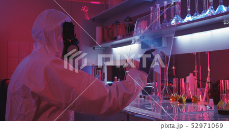 Scientist using transparent display in laboratory Scientist using transparent display in laboratory 52971069