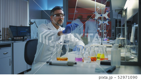 Scientist using a flat transparent display screen Scientist using a flat transparent display screen 52971090