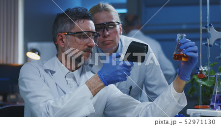 Scientists examining various liquids 52971130