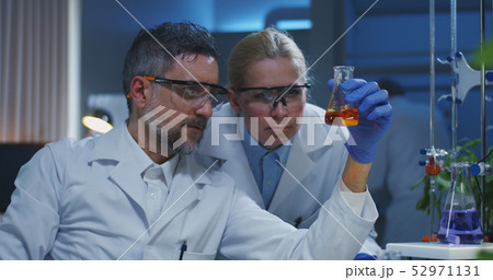 Scientists examining various liquids Scientists examining various liquids 52971131