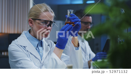 Scientists examining liquid Scientists examining liquid 52971132