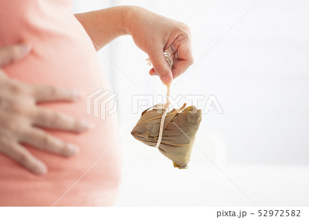 hand holding  traditional  rice dumplings  and big 52972582