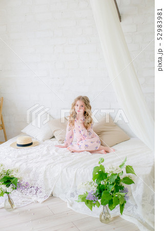 little girl with blond hair with lilac flowers little girl with blond hair with lilac flowers 52983981