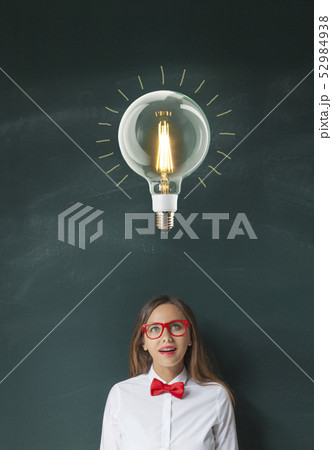 Light Bulb and Young Woman on Blackboard 52984938