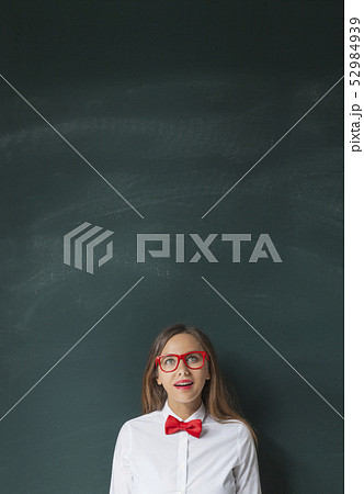 Young woman looking up with blackboard Young woman looking up with blackboard 52984939