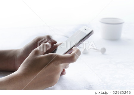 woman hang holding cellphone in morning breakfast woman hang holding cellphone in morning breakfast 52985246