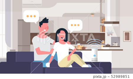 couple sitting on couch man woman using smartphone smart speaker voice recognition concept chat 52989851