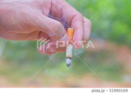 man hand holding a cigarette for smoking close up man hand holding a cigarette for smoking close up 52990109