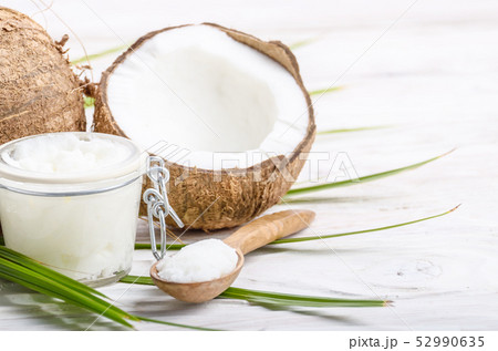 Coconut oil in airtight glass jar spoon and shell Coconut oil in airtight glass jar spoon and shell 52990635