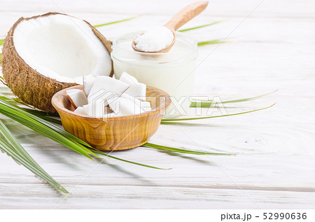 Coconut shell hard oil in glass jar and coconut 52990636