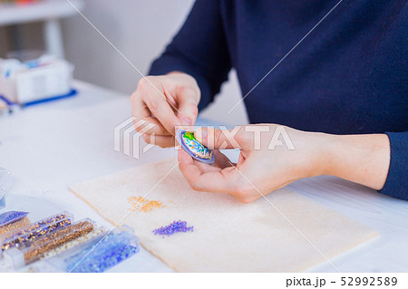 Designer making handmade brooch 52992589