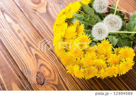 Basket with yellow dandelion flower Basket with yellow dandelion flower 52994089