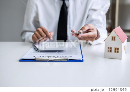 Real estate agent Sales manager holding filing 52994346