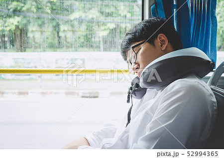 Young Asian man traveler sitting on a bus and Young Asian man traveler sitting on a bus and 52994365