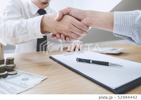 Real estate broker agent and customer shaking Real estate broker agent and customer shaking 52994442