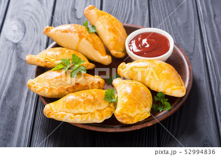 Latin American baked beef empanadas with sauce 52994836