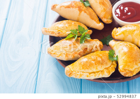 Latin American baked beef empanadas with sauce 52994837
