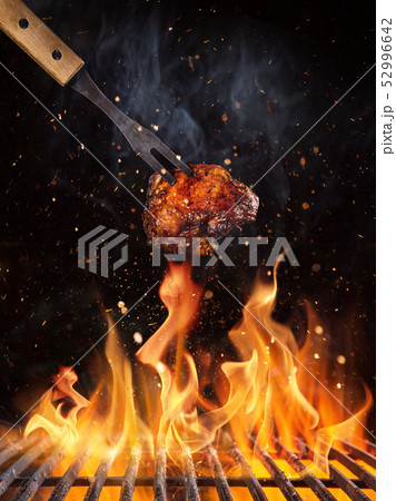 Chicken piece on the grill with flames 52996642