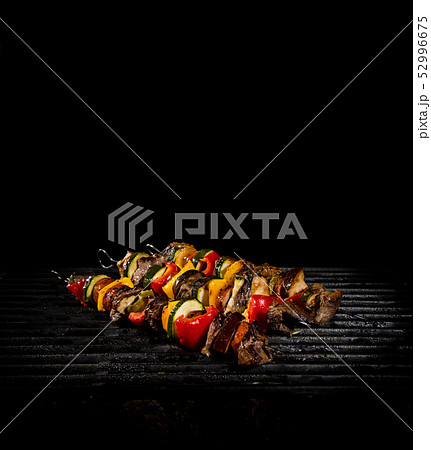 Tasty skewers on the grill with flames 52996675
