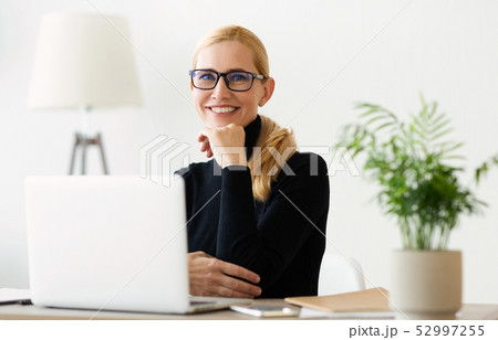 Happy Mature Businesswoman Working On Laptop At Home Office Happy Mature Businesswoman Working On Laptop At Home Office 52997255