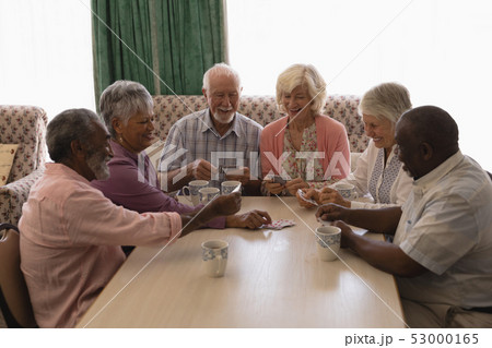 Group of senior people playing cards in living room 53000165