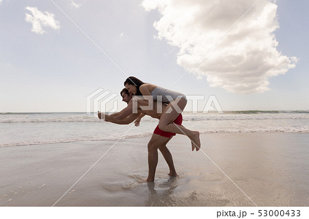 Young couple piggyback and  taking selfie with mobile phone 53000433