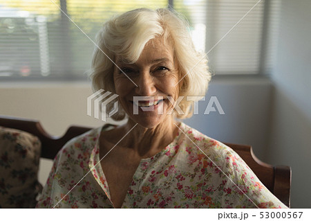 Senior woman relaxing in living room at home Senior woman relaxing in living room at home 53000567