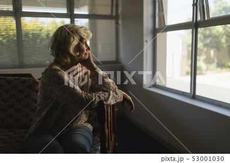Senior woman relaxing in living room at nursing home Senior woman relaxing in living room at nursing home 53001030