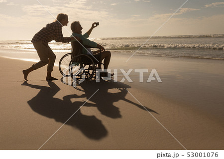 Senior couple taking selfie with mobile phone on the beach Senior couple taking selfie with mobile phone on the beach 53001076