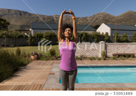 Woman performing yoga in the backyard 53001889