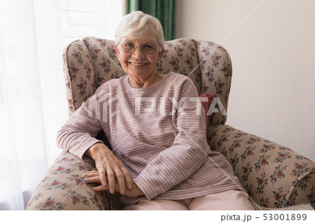 Front view of senior woman looking at camera in home 53001899