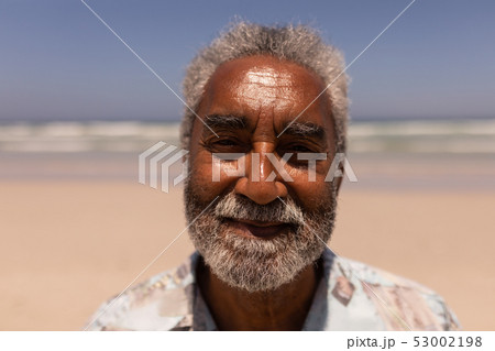 Senior black man looking at camera on beach Senior black man looking at camera on beach 53002198