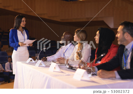 Business colleague discussing with each other in the auditorium  53002372