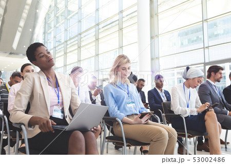 Business people attending a business seminar 53002486