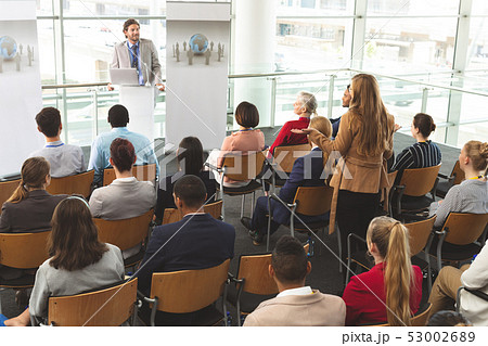 Businesswoman interacting with male speaker in a business seminar 53002689