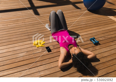 Woman relaxing in the backyard of home 53002892