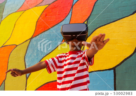 Schoolboy using virtual reality headset in the school playground Schoolboy using virtual reality headset in the school playground 53002983
