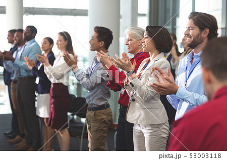 Happy business people applauding in a business seminar 53003118