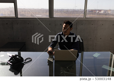 Businessman using mobile phone in the office Businessman using mobile phone in the office 53003148
